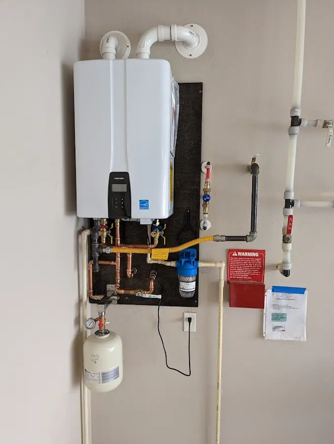 Professional plumber installing copper piping in a West Pikeland home